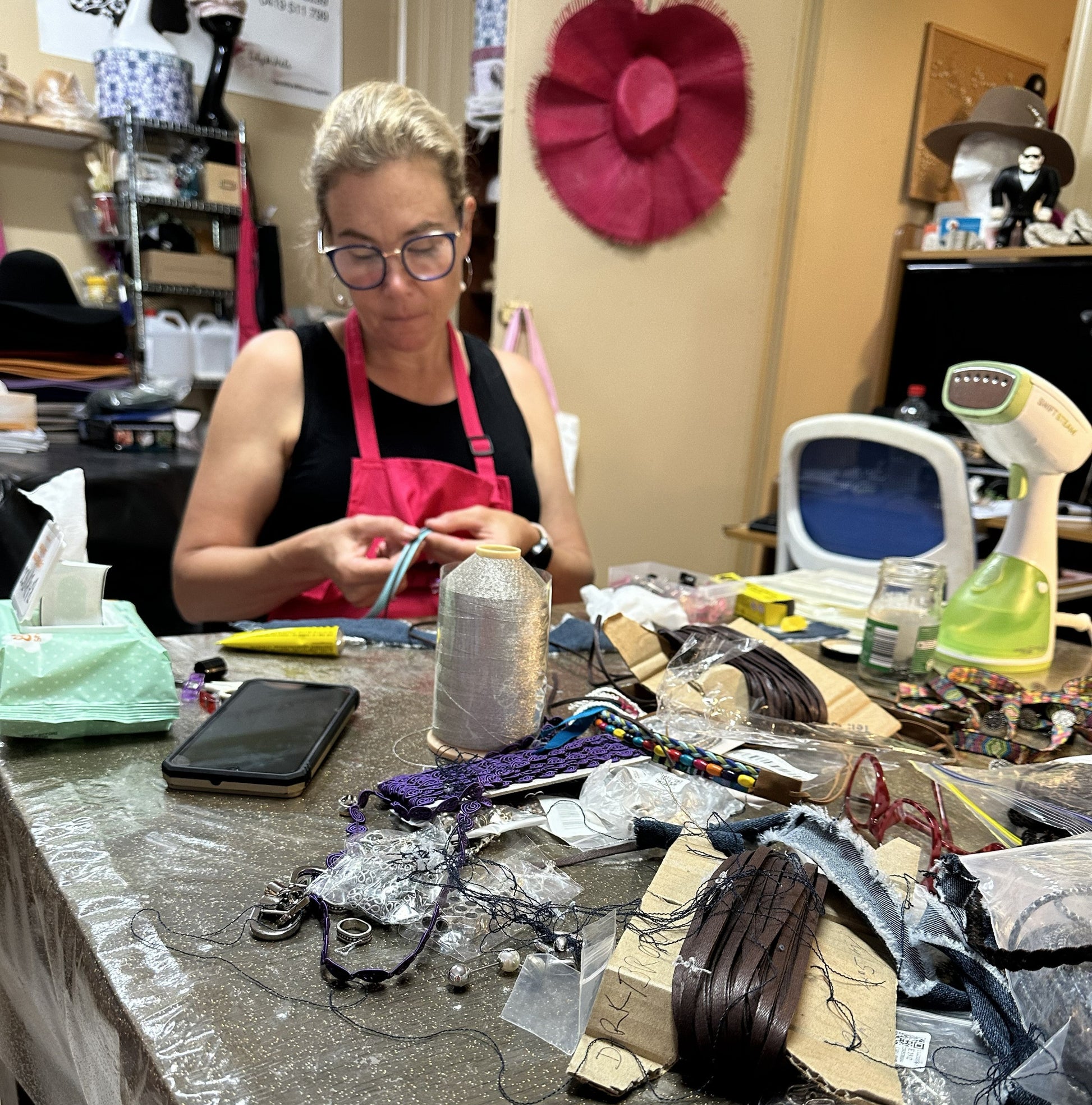Person working on hat accessories at a  in a retreat setting